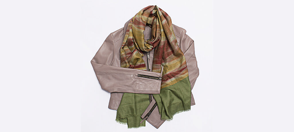 The Secret Room Boutique flat lay with bovine leather jacket and cashmere scarf